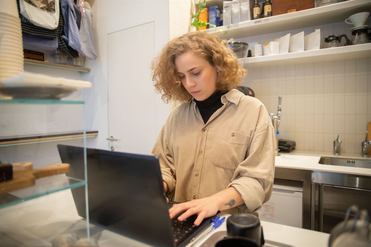 A small business owner working on a laptop